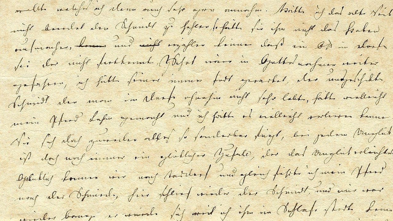 Handschriftlicher Brief mit dicht beschriebenen Zeilen in schwarzer Tinte auf beigefarbenem Papier